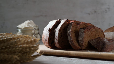 Slices of homemade beetroot bread, and crispy wheat and rye bread. On a wooden board.