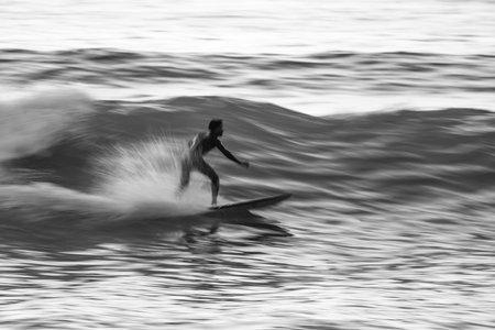 Local surfer riding waves with a short board in Furadouro beach, Portugal. Men catching waves in...