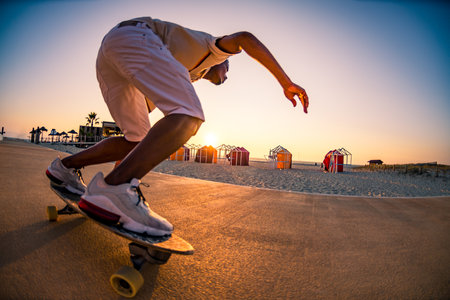 Surf skater training surfing moves near the beach at sunset.