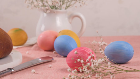 Easter folar with eggs on table top and pink tablecloth.の写真素材