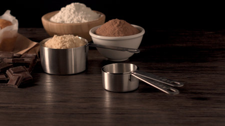 Homemade muffins with chocolate and baking ingredients.
