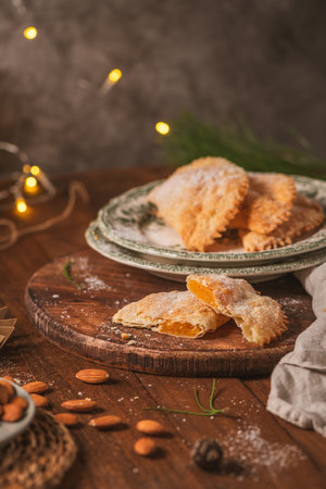 A crescent-shaped pastry whose filling is made of eggs and almonds wrapped in crispy dough, cut in...