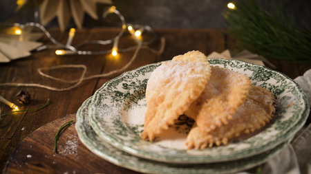 A crescent-shaped pastry whose filling is made of eggs and almonds wrapped in crispy dough, cut in...