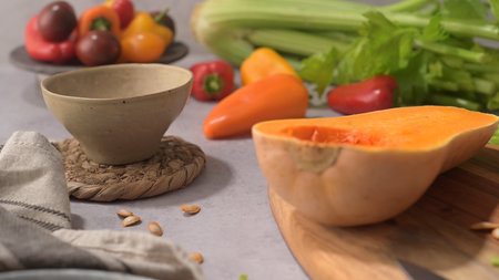 Autumn vegetables arranged on a kitchen worktop while preparing a pumpkin soup.の写真素材