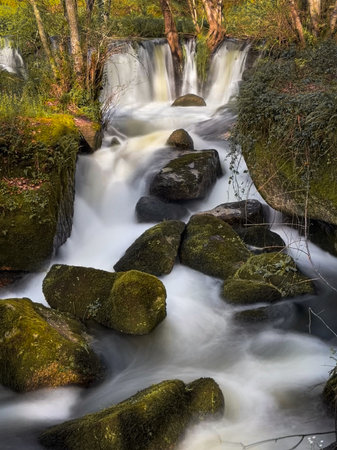 View over a waterfall on the Cavalo River along the Trilho dos Gaios in Tabua, Coimbra - Portugal.の写真素材