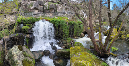 View over a waterfall on the Cavalo River along the Trilho dos Gaios in Tabua, Coimbra - Portugal.の写真素材