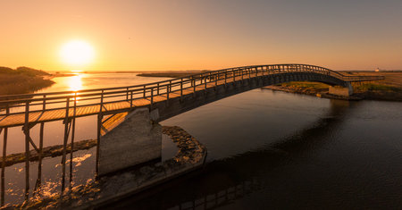 Wooden bridge over the water. Autumn sunset light in Esmoriz, Ovar - Portugal.の写真素材