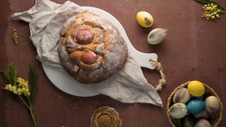 Easter folar with egg on wooden table top.