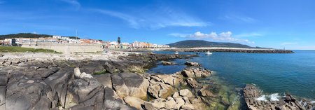 A picturesque seaside of Vila Praia de Ancora in Portugal, nestled between rocky shores and azure skies.の写真素材