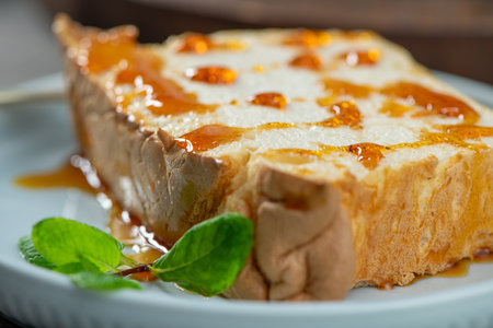 A close-up captures a single slice of molotof, a traditional pudding made from caramelized egg...