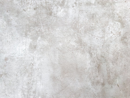 Mottled light gray backdrop with a slightly rough feel, suitable for overlays or backgrounds.の写真素材