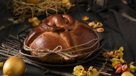 Easter folar with egg on wooden table top.