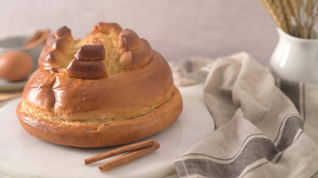 Homemade sweet buns with raisins and cinnamon on a white plate