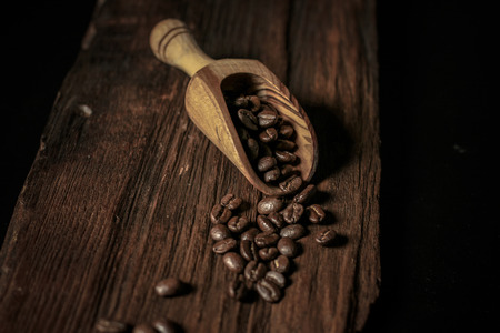 Coffee beans wood scoop on the vintage woodの写真素材