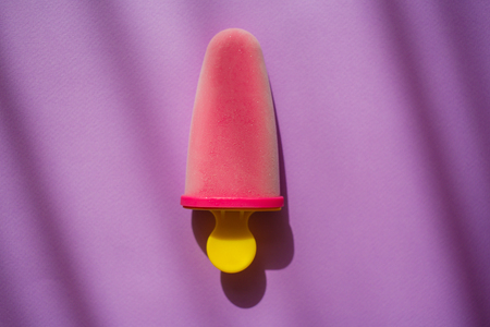 Frozen natural purple ice cream on colorful violet background with shadows. Sweet summer.の写真素材