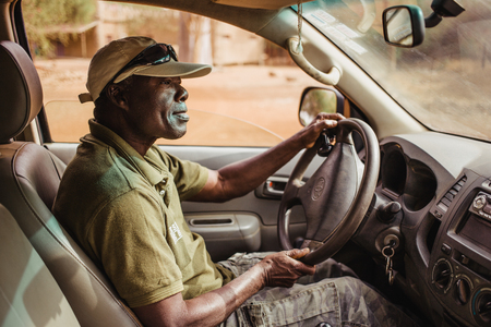 Afro-american Driver of Jeep Safari in Senegal, Africa. View from passenger's seat.のeditorial素材
