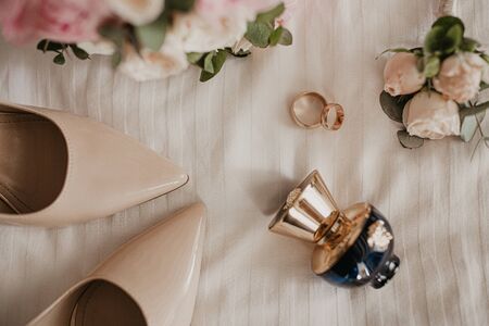 Accessories for the bride: rings, shoes, wedding bouquet and perfume. Morning bride. Wedding details.の写真素材
