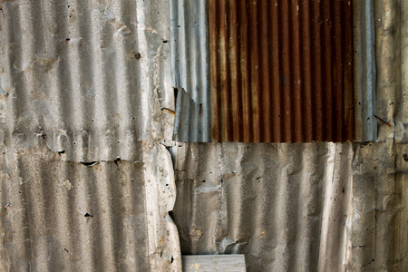 old steel plate set beside the street and obstructs people to entry at the same time.の写真素材