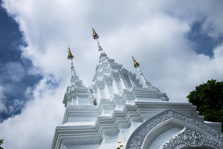 The traditionally decorated entrance way for thai temple situated in front of cloudy background. June, 22-2016  Chiang Mai, Thailand.の写真素材