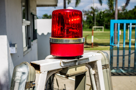 Warning light stands alone in front of some place with blurry background.の写真素材