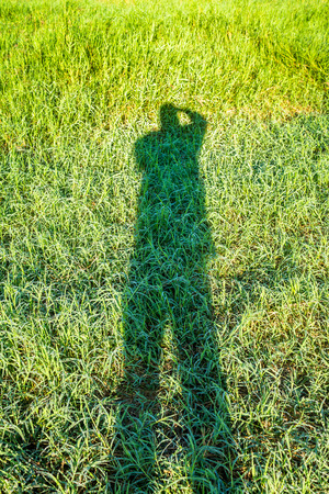 A photographer picturing self silhouette in natural background.の写真素材