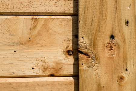 Wooden panel closely pictured in detail for texture background usage.