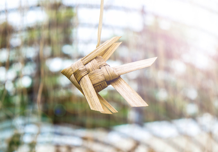 Natural Thai plai weaved fish lullaby. Handmade traditional decoration from leaves. Lens flare lighting.の写真素材