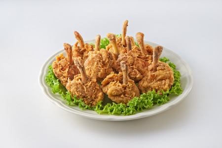 Fried chicken drum stick in plate on clean backgroundの写真素材