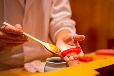 Sushi Chef is preparing Tuna Sushiの写真素材