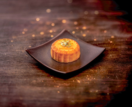Luxury mooncake with gold topping on a plateの写真素材