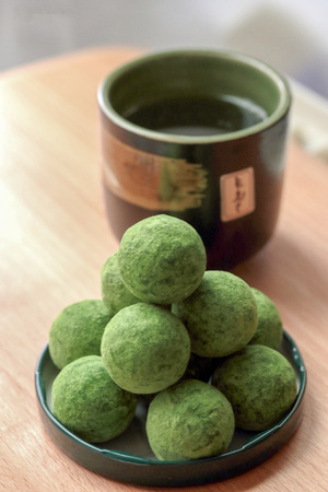 close up green tea chocolate ball with green tea setting