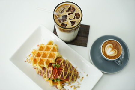 Belgian waffles with Coffee Latte and Iced Coffee on white backgroundの写真素材