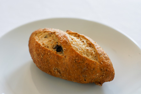 rustic loaf bread with raisin on white plate