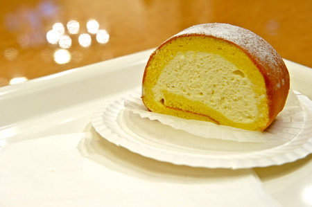 Creamy swiss roll on a white dish 