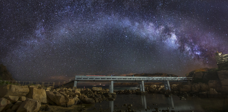 Curved Milky Way over a bridgeの写真素材