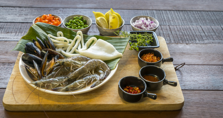 Raw seafood on plate, healthy food, prawn, clam squid.の写真素材