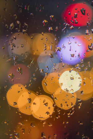 Water drops on window with color backgroundの写真素材