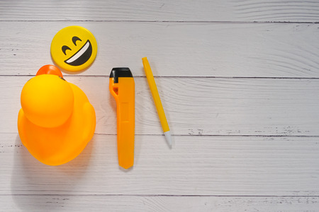 Yellow toys and yellow pens placed on the table