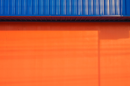 Orange wall cut with blueの写真素材