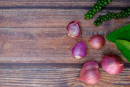 Shallots, spices for cooking on the wooden floor in the kitchenの写真素材