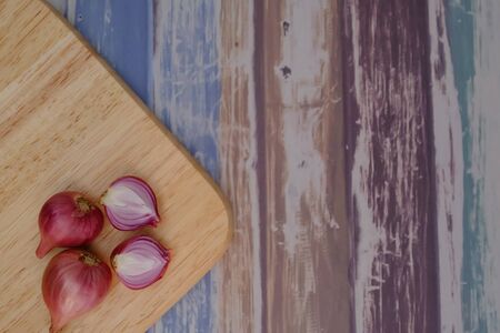 Shallots on the wooden floor in the kitchenの写真素材