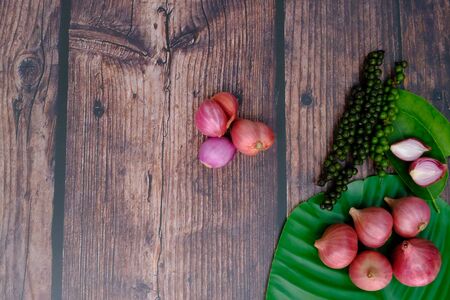 Shallots on the wooden floor in the kitchenの写真素材