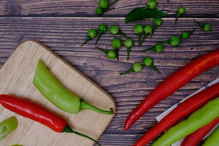 Red-green chillies on the wood floor in the kitchenの写真素材