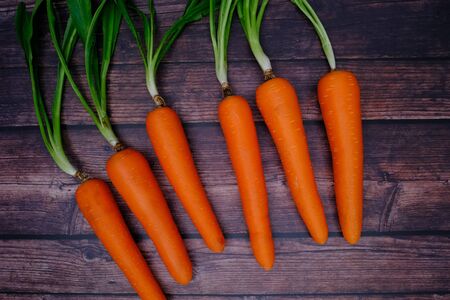 Carrots on the wooden floor in the kitchen