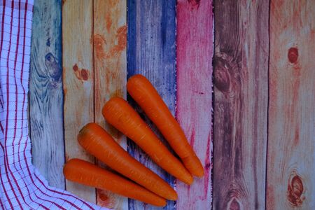 Carrots on the wooden floor in the kitchenの写真素材