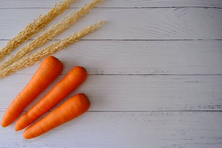 Carrots on the wooden floor in the kitchenの写真素材