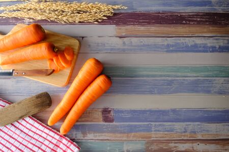 Carrots on the wooden floor in the kitchenの写真素材
