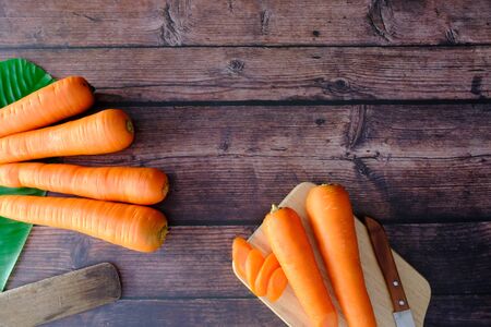 Carrots on the wooden floor in the kitchenの写真素材