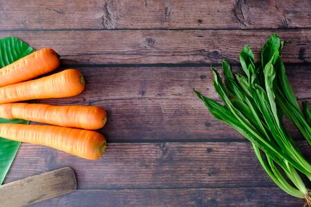 Carrots on the wooden floor in the kitchenの写真素材