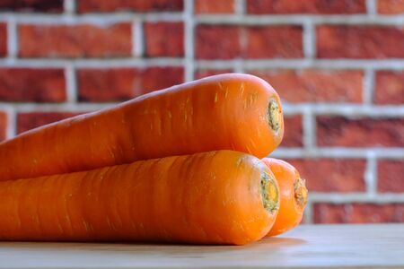 Carrots on the wooden floor in the kitchenの写真素材